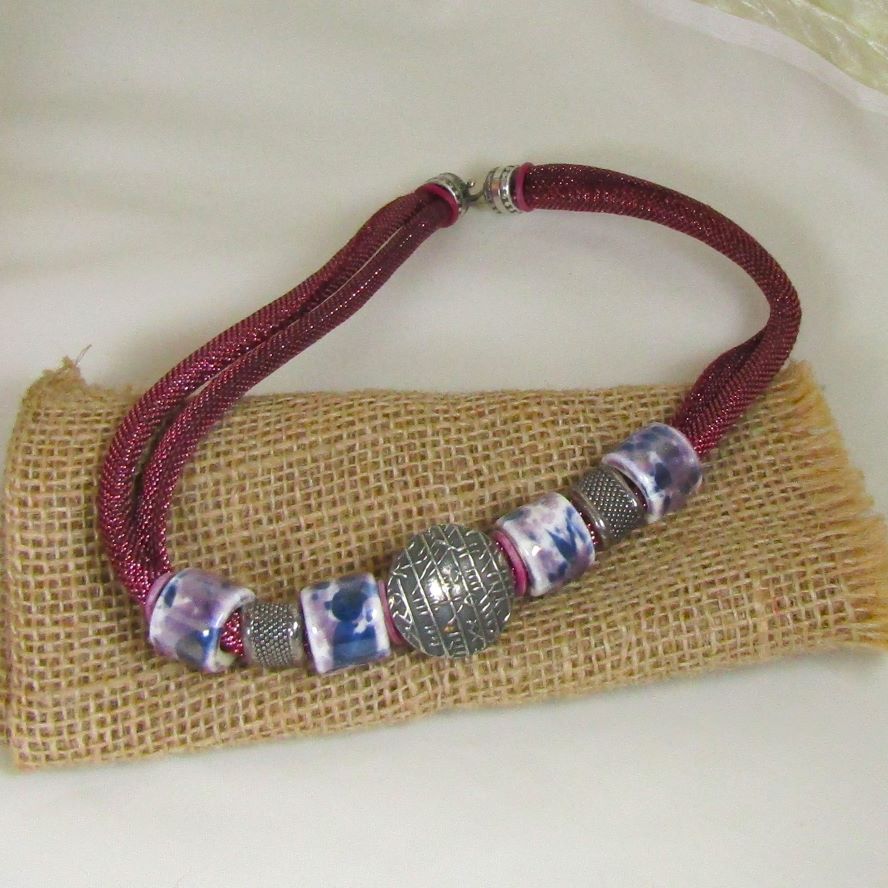 alluring necklace hi-lights the supple metallic cotton cord accented with handmade ceramic beads