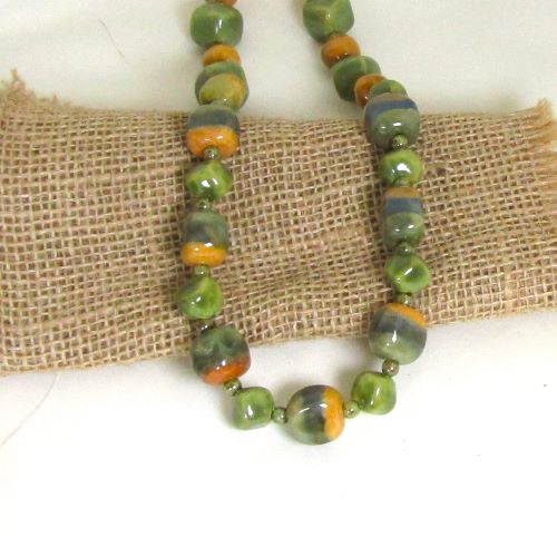 Earthy tones of green and mustard fair trade beads in a Kazuri necklace