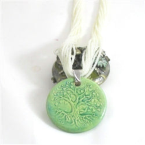 white muktistrandnecklace with green pendant