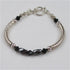 Classic pairing of hemitite and sterling silver in a bangle bracelet