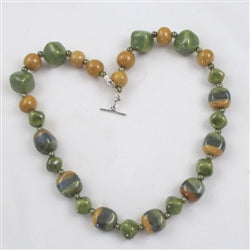 Earthy tones of green and mustard fair trade beads in a Kazuri necklace